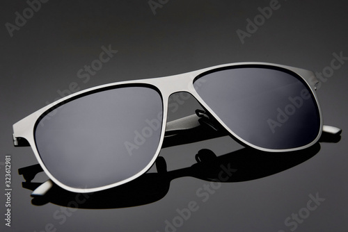 Sunglasses for men on black glossy glass