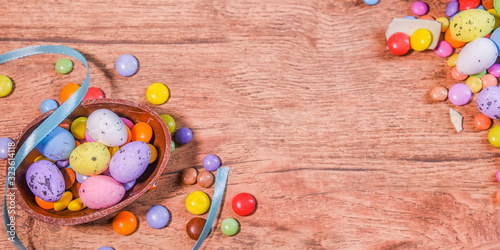 Easter composition with chocolate eggs on  wooden background