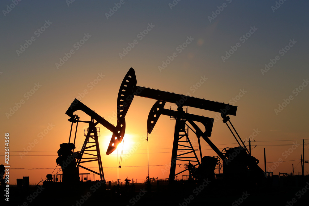 Oil pumps at work against the setting sun