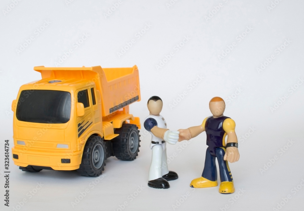 Men shake hands near the truck Men shake hands near the truck