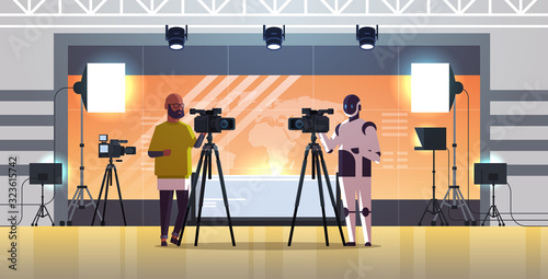 robotic operator with cameraman using video camera on tripod robot vs human standing together broadcasting artificial intelligence technology concept news studio interior full length horizontal vector