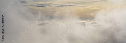 Landscape panoramic aerial above the clouds over the United Kingdom at sunrise