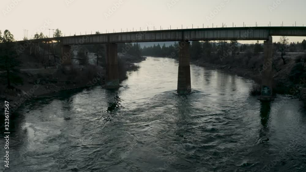 Drone flying up Spokane River with railroad bridge Drone flying up Spokane River with railroad bridge