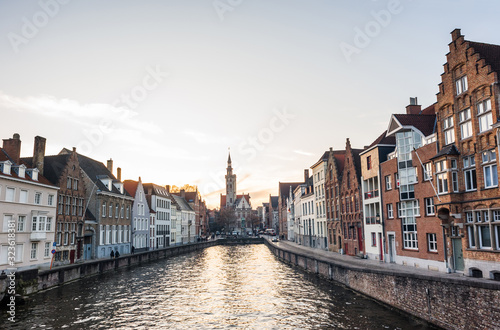 Charming street and canal at sunset in Bruges old town, Belgium. Popular travel destination and tourist attraction in Europe