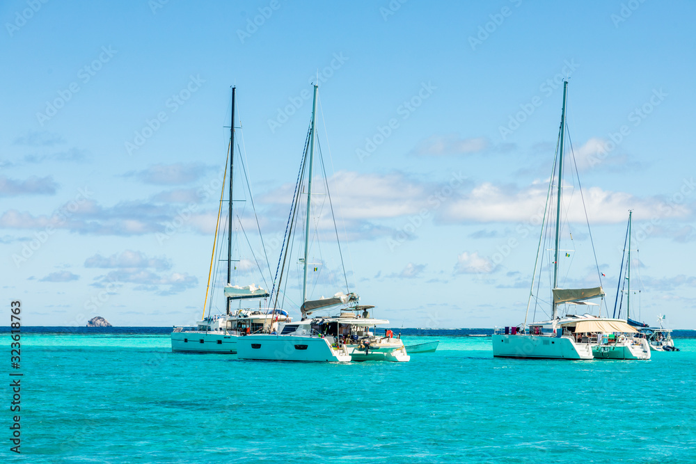 Turquoise colored sea with ancored catamarans, Tobago Cays, Saint Vincent and the Grenadines, Caribbean sea