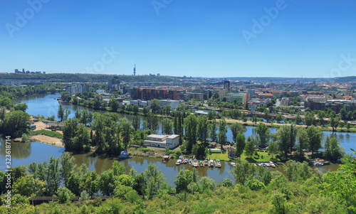 Holesovice, district of Prague, capital of Czech Republic, Central Europe. Vltava river in foreground surrounded by riverside residential neighborhood area.