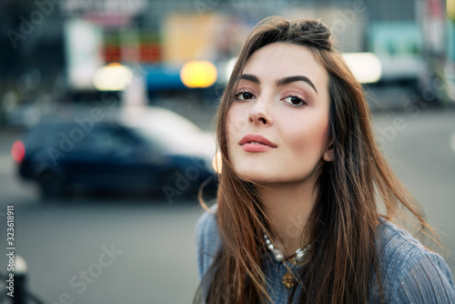 Close up young beautiful woman portrait posing in the city street