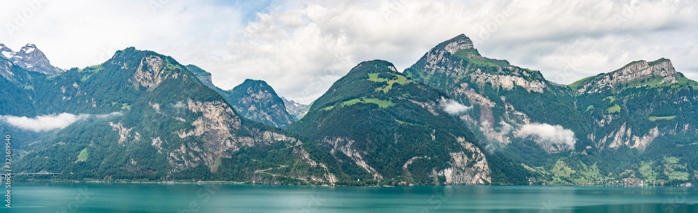Switzerland, Panoramic view on green Alps and lake near Bauen, Isleten
