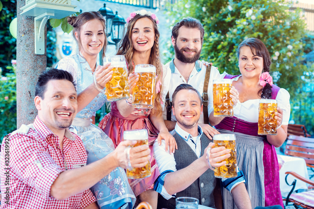 Group of merry people drinking beer looking into the camera Group of merry people drinking beer looking into the camera