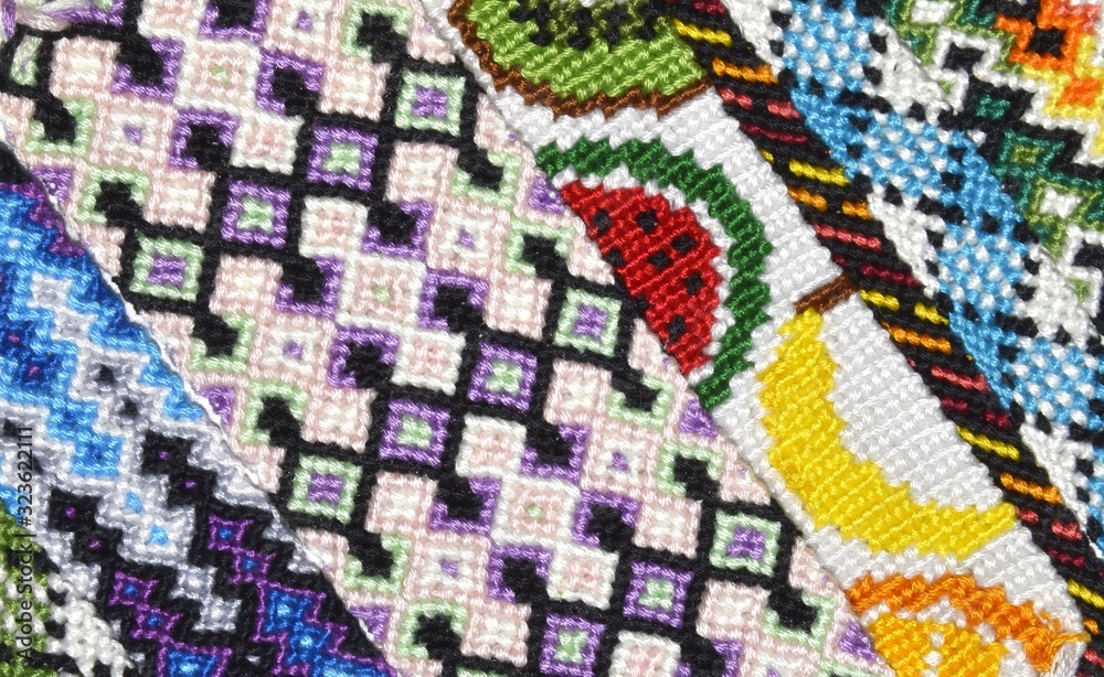 Multi-colored bright background with unusual pattern handmade of thread and knots Multi-colored bright background with unusual pattern handmade of thread and knots
