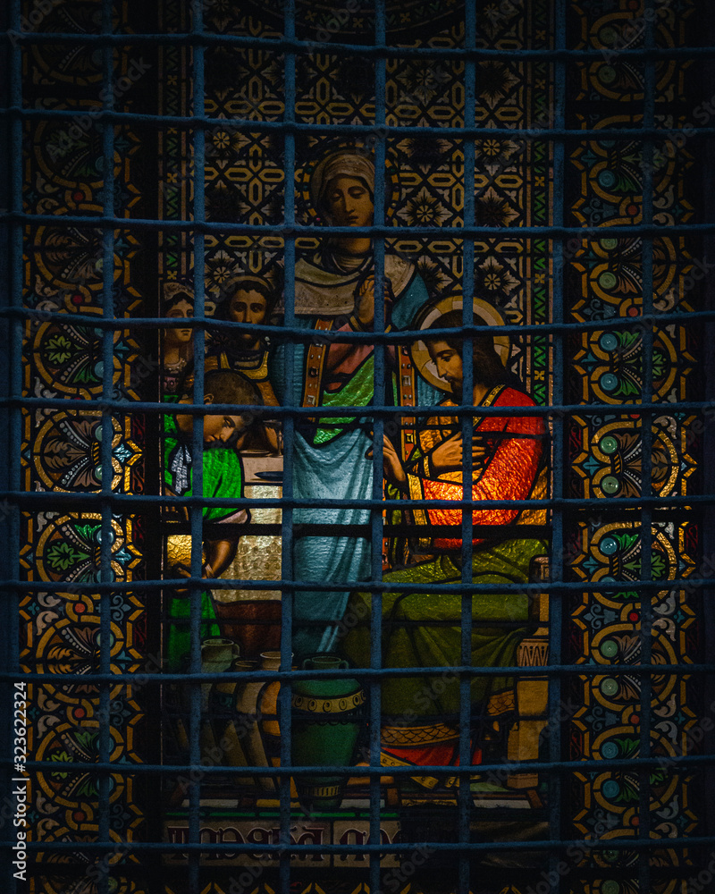 Beautiful glass of Montserrat with religious images in front of a fence