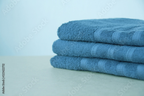 pile of clean terry bath towels  close-up  on a light background  copy space  concept of cleanliness  bath procedure  spa