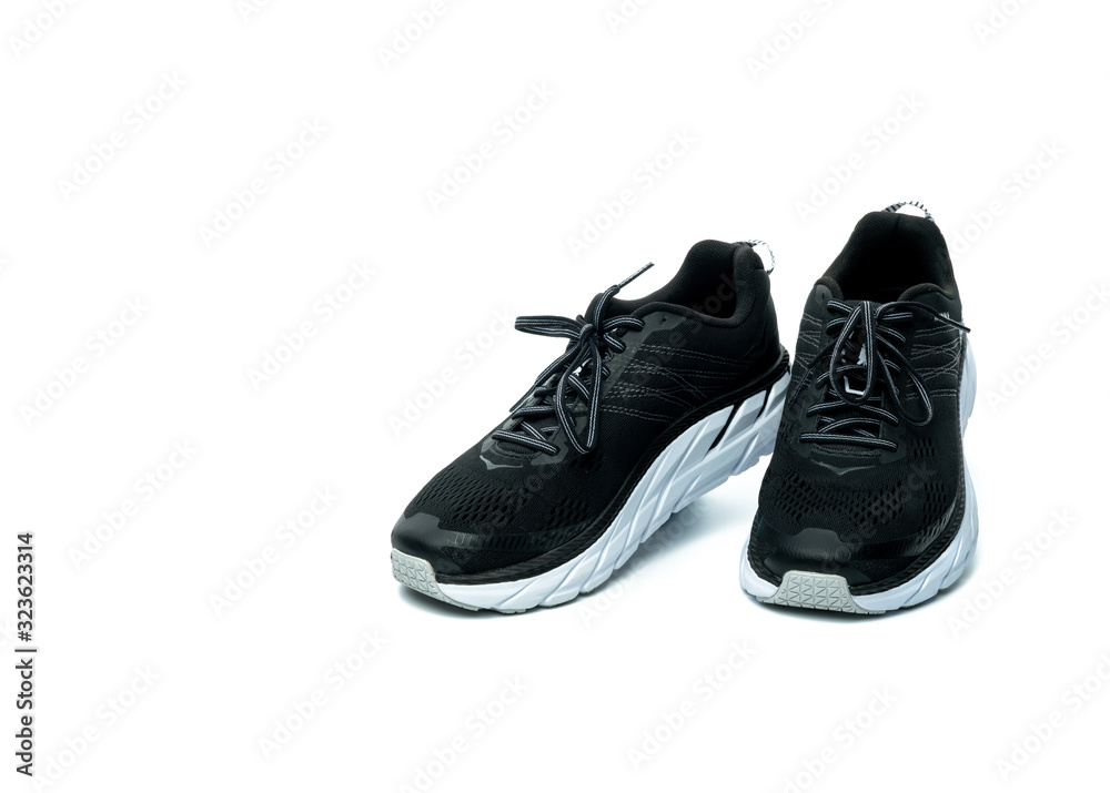 Pair of new running shoes isolated on white background. Black sneakers. Breathable fabric sport shoes with high abrasion rubber outsole. Footwear of gym trainer. Light and comfortable running shoes.