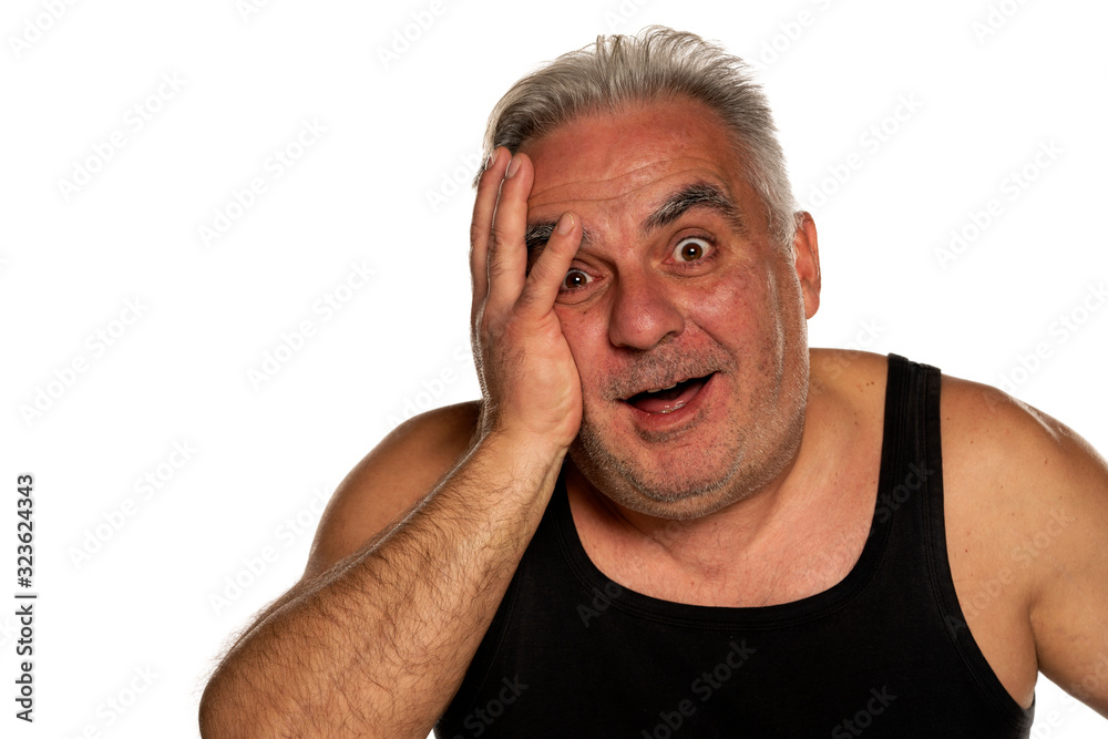 Obraz premium Happy and shocked middle aged man with short gray hair