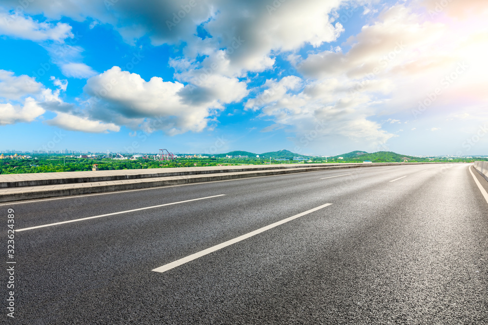 Fototapeta premium Empty asphalt highway and city suburb skyline on a sunny day in Shanghai.