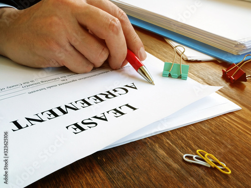 Fotografie Man is signing lease agreement by the pen.