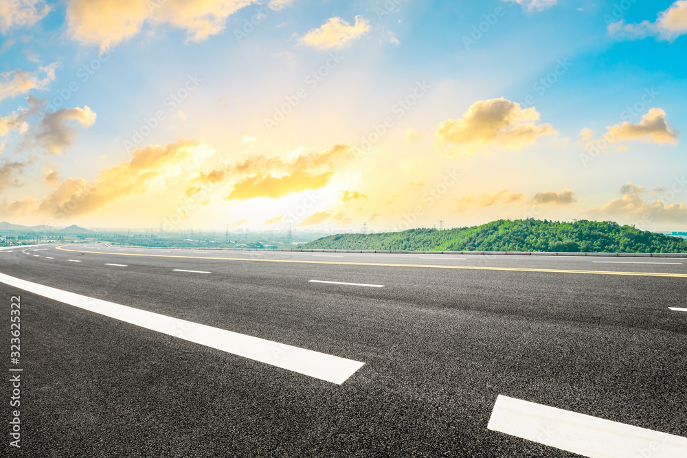 Empty asphalt road and green hill with beautiful sky sunset clouds. Empty asphalt road and green hill with beautiful sky sunset clouds.