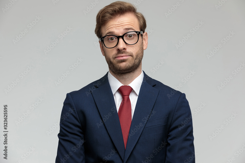 businessman standing and looking at camera surprised businessman standing and looking at camera surprised