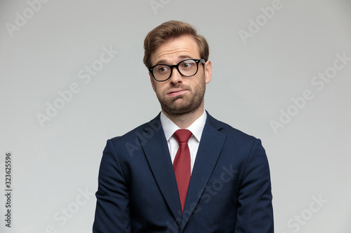 businessman standing and holding air in his mouth anxious photo
