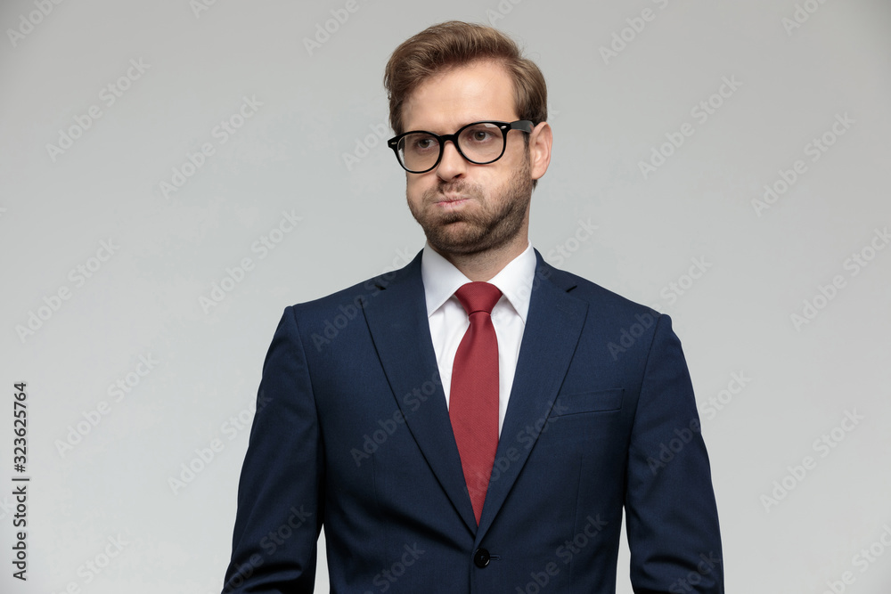 businessman standing and puffing cheeks anxious businessman standing and puffing cheeks anxious