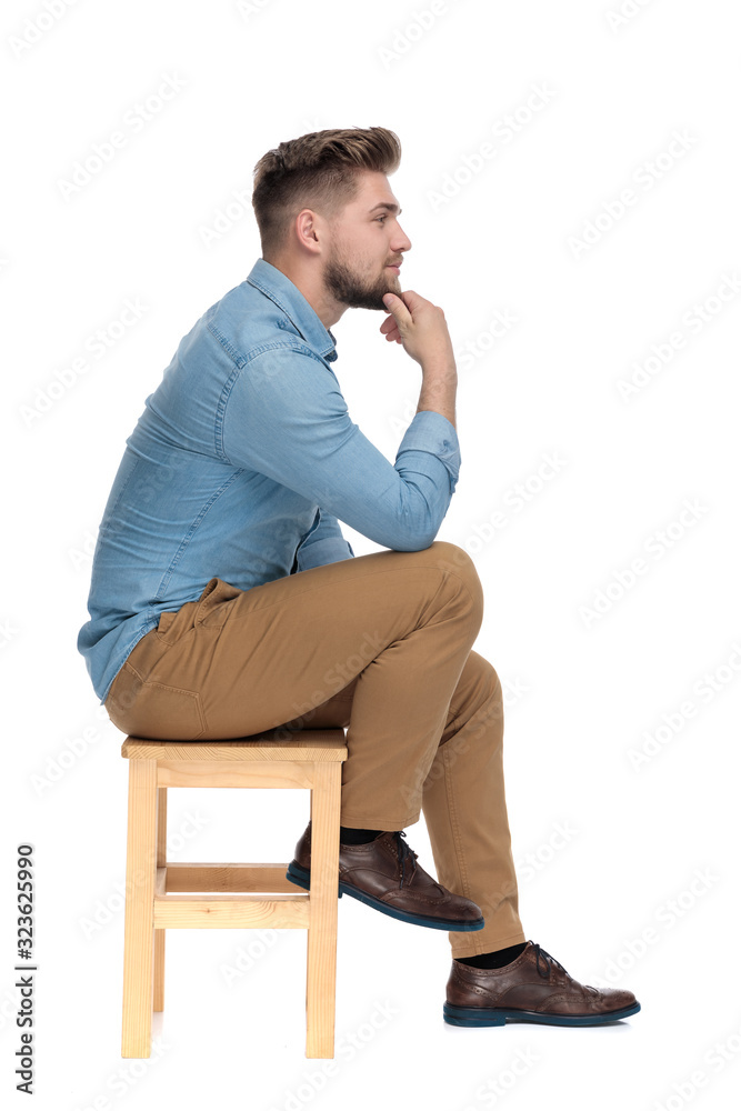 thoughtful casual guy holding hand to chin and thinking thoughtful casual guy holding hand to chin and thinking
