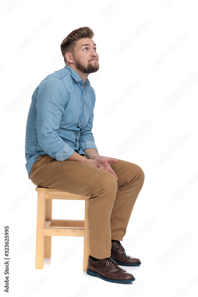 cute young guy in denim shirt looking up and praying