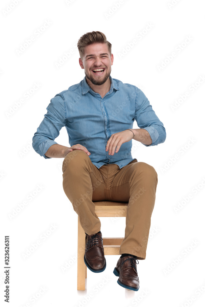 happy casual man wearing denim shirt and laughing