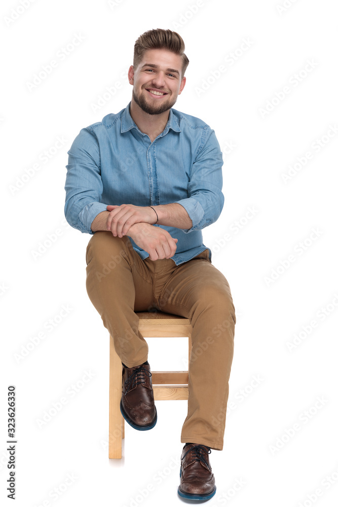 smiling casual man wearing denim shirt and holding hands smiling casual man wearing denim shirt and holding hands