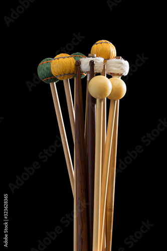 Slika na platnu Percussion Mallets over black plain background