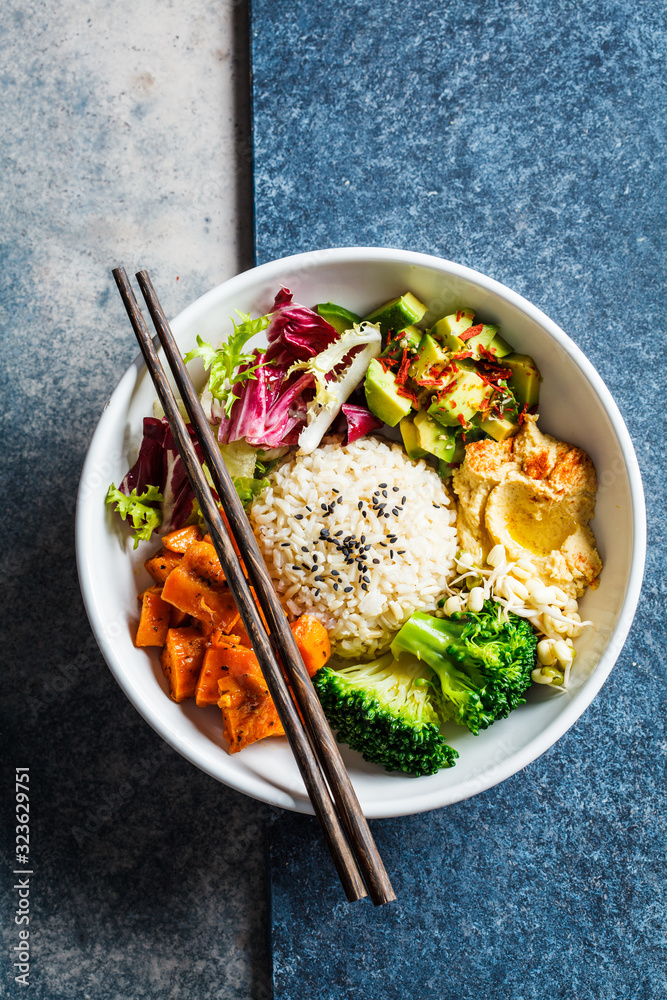 Vegan rice and vegetables salad, top view. Macrobiotic set with rice, hummus, avocado, broccoli and sweet potato. Vegan rice and vegetables salad, top view. Macrobiotic set with rice, hummus, avocado, broccoli and sweet potato.