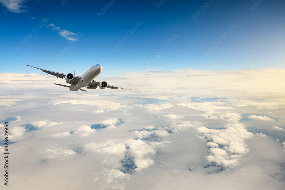 Fototapeta premium Airplane flying at high altitude and beautiful high-altitude clouds in spring