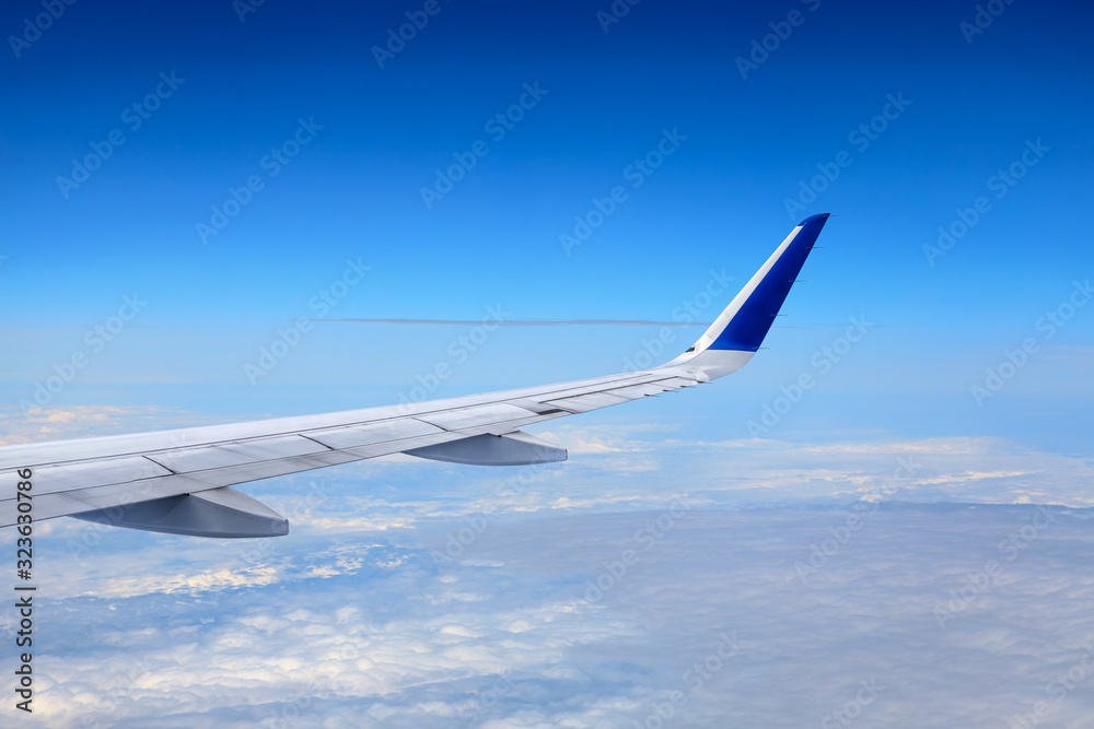 Fototapeta premium Airplane flying at high altitude and beautiful high-altitude clouds in spring