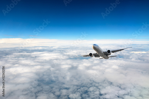 Airplane flying at high altitude and beautiful high-altitude clouds in spring