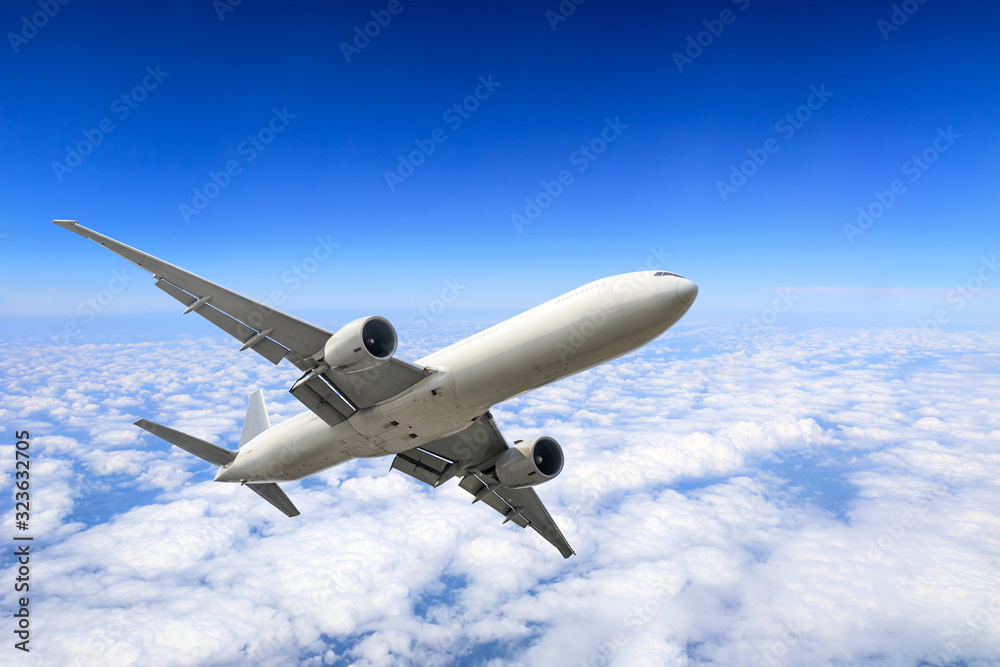 Airplane flying at high altitude and beautiful high-altitude clouds in spring