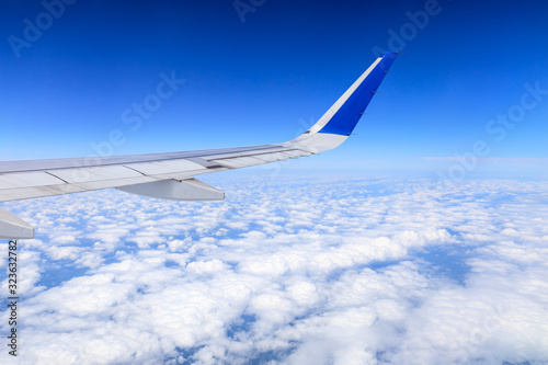 Airplane flying at high altitude and beautiful high-altitude clouds in spring