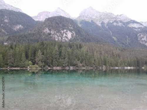 Mountains rise above the green lake