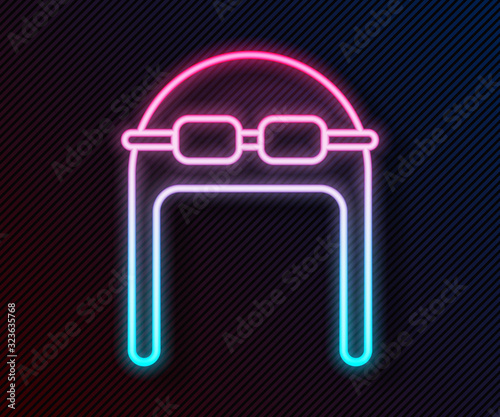 Glowing neon line Aviator hat with goggles icon isolated on black background. Pilot hat. Vector Illustration