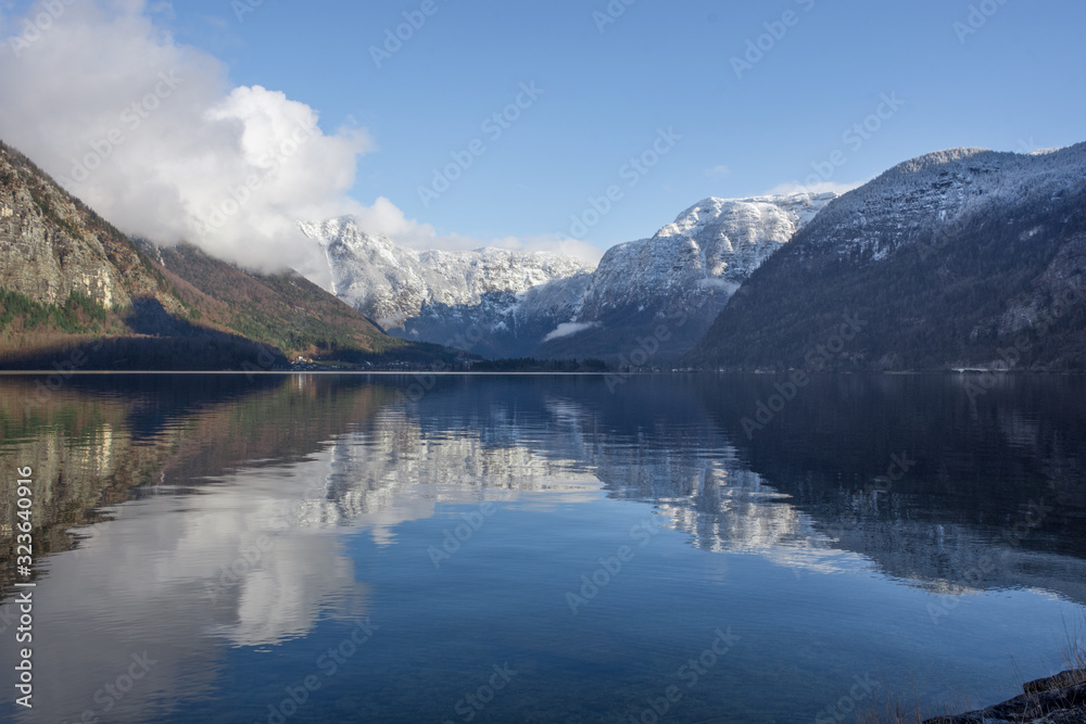 The clear water of Hallstattersee lake and the beautiful mountains surrounding it in Salzkammergut region, Austria, in winter The clear water of Hallstattersee lake and the beautiful mountains surrounding it in Salzkammergut region, Austria, in winter