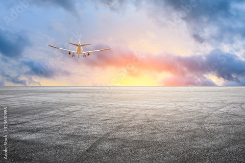 Empty asphalt road and sky airplane landscape at sunset