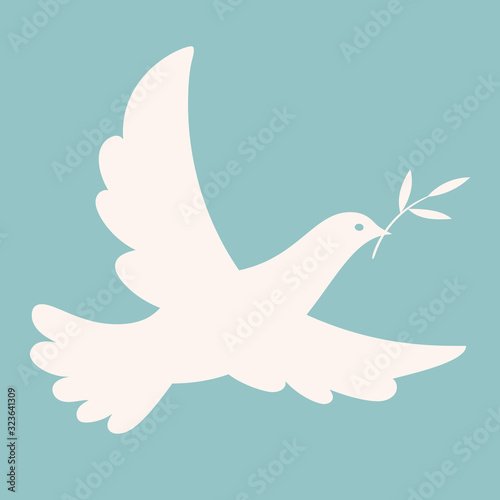 Isolated dove with an olive branch flying in the blue sky