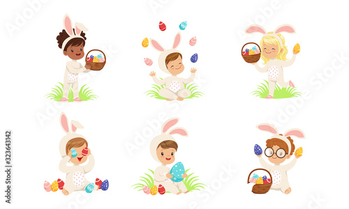 Happy Easter, Collection of Cute Little Boys and Girls Dressed in Bunny Costumes Sitting on the Grass with Colorful Easter Eggs Vector Illustration