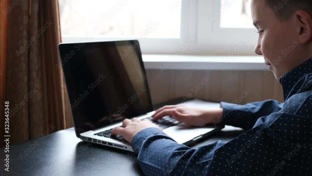 laptop on the table and hands pushing the keyboard