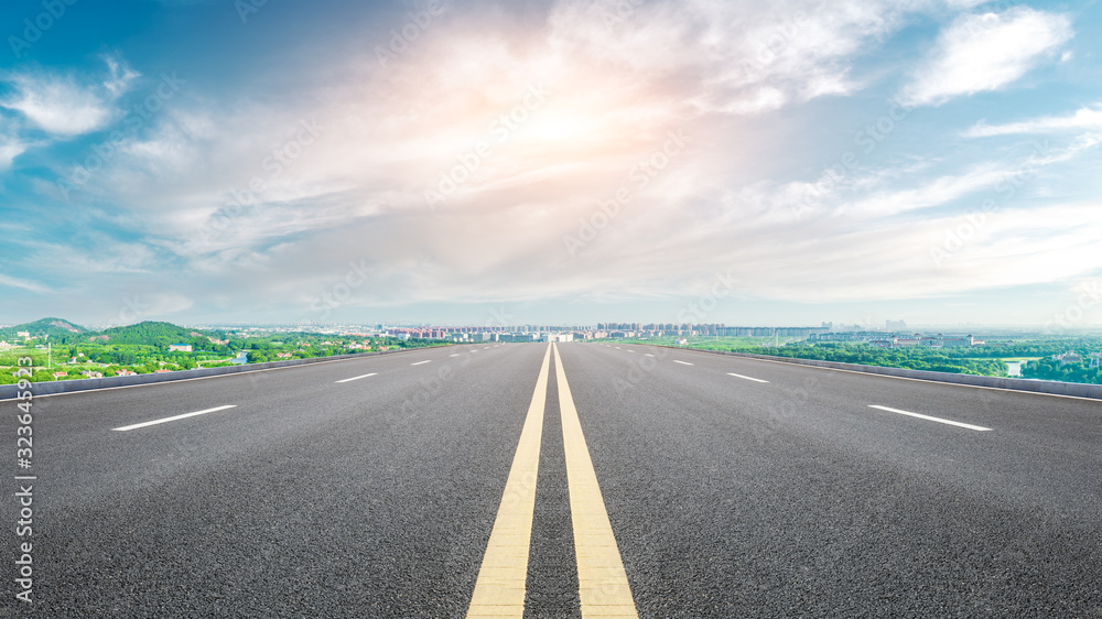 Naklejka premium Empty asphalt highway and city suburb skyline on a sunny day in Shanghai.