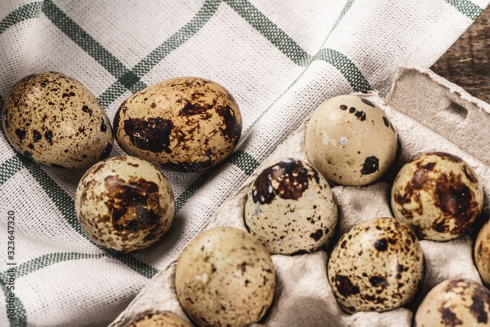 Quail eggs in cardboard box.