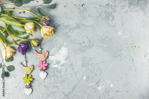 Flowers composition. Violet and light yellow tulip flowers on gray concrete background. Valentine's day, Mother's day concept. Flat lay, top view, copy space