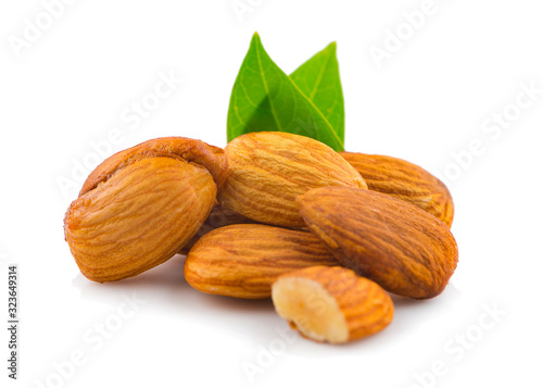 Almonds with green leaves an isolated on white background