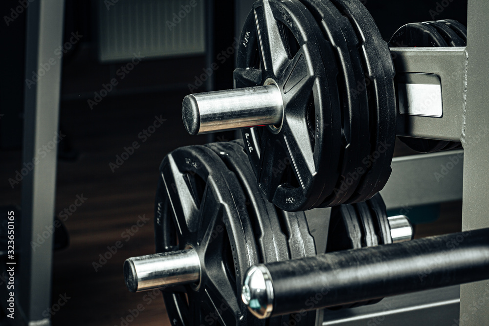 Gym weight plates on holder close up