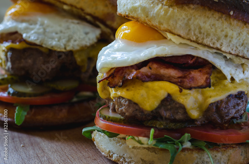 Cheeseburger in homemade brioche bun with bacon and fried egg