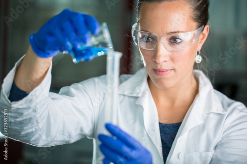 Female researcher carrying out scientific research in a lab  shallow DOF  color toned image 