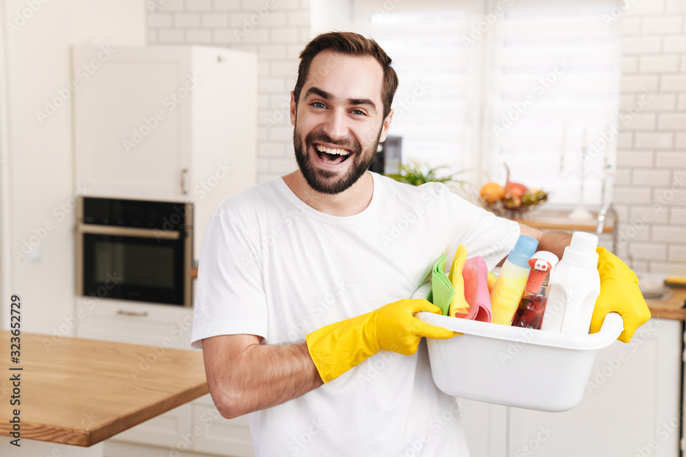 Positive man househusband indoors. Positive man househusband indoors.